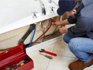 Plumber inspecting pipes