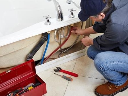 Plumber inspecting pipes